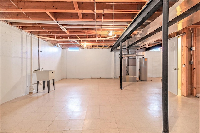 basement with water heater and sink