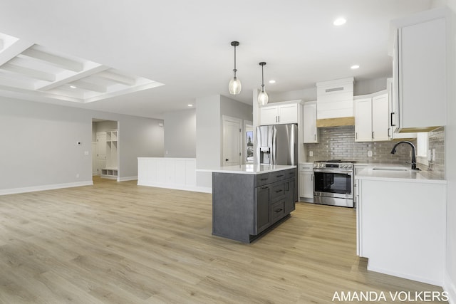 kitchen with a kitchen island, decorative light fixtures, white cabinetry, sink, and stainless steel appliances