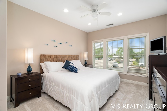 bedroom featuring light colored carpet and ceiling fan