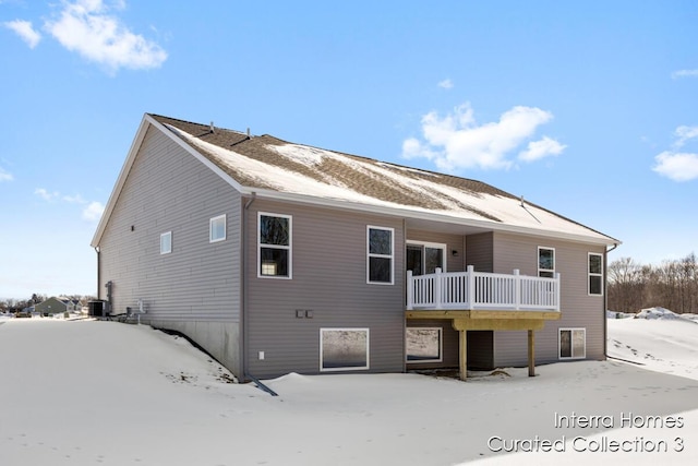 snow covered property featuring a deck