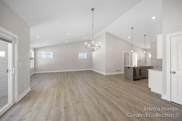 unfurnished living room with light wood-style flooring, recessed lighting, a sink, visible vents, and baseboards