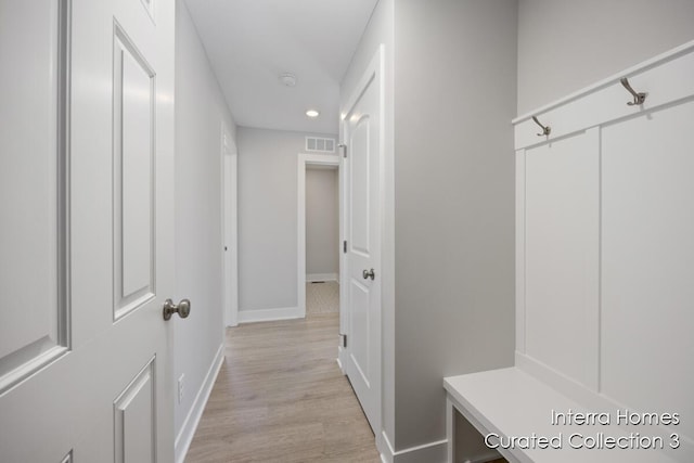 mudroom featuring light wood-type flooring, baseboards, visible vents, and recessed lighting