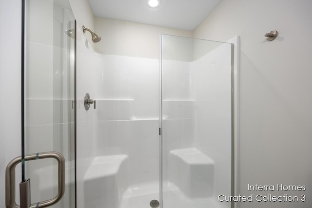 full bath featuring a shower with shower door