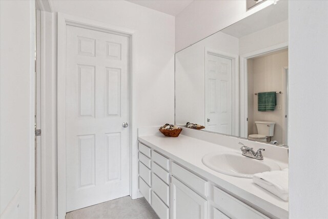 bathroom with toilet and vanity