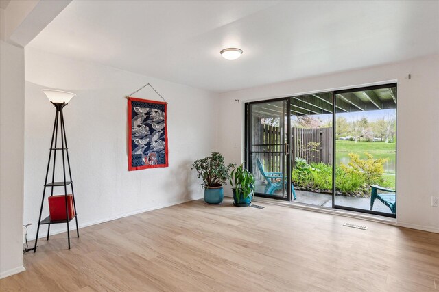 empty room featuring wood finished floors and baseboards