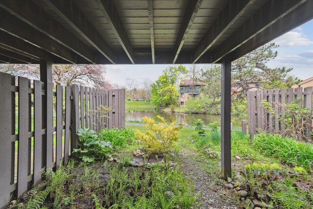 view of yard featuring fence and a water view