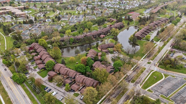 aerial view of property's location featuring a nearby body of water and nearby suburban area