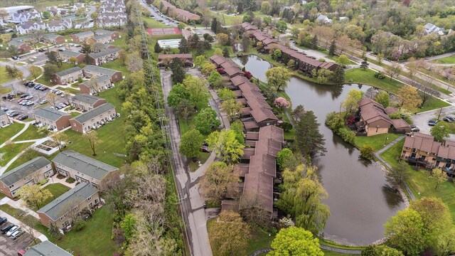 view of property location featuring a large body of water and nearby suburban area
