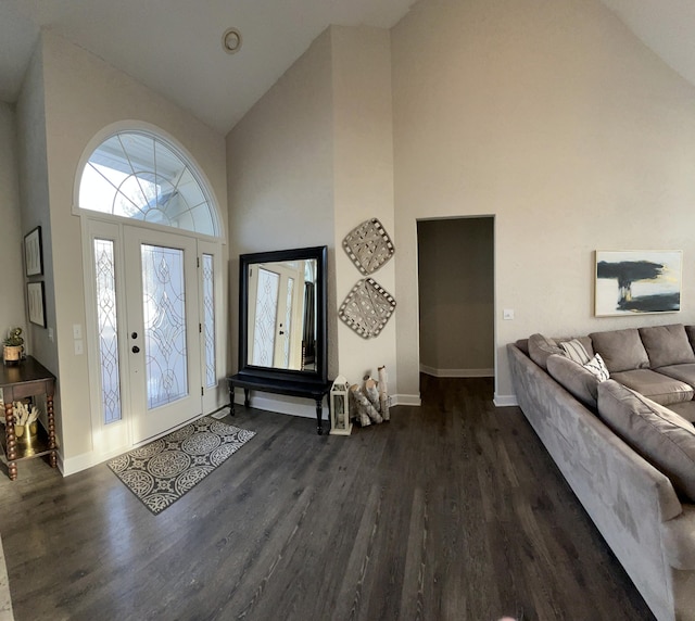 entryway with dark wood-type flooring and high vaulted ceiling