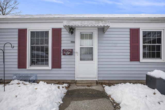 view of snow covered property entrance