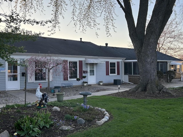 view of front of property with a yard and a patio area