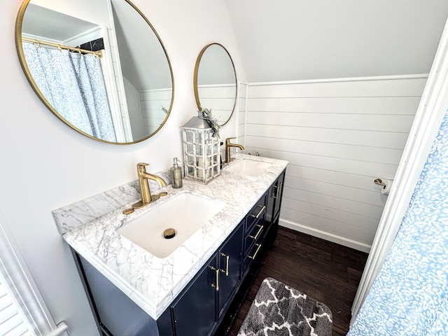 bathroom with vanity, hardwood / wood-style floors, and wood walls