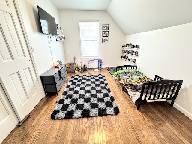 playroom with vaulted ceiling and hardwood / wood-style floors