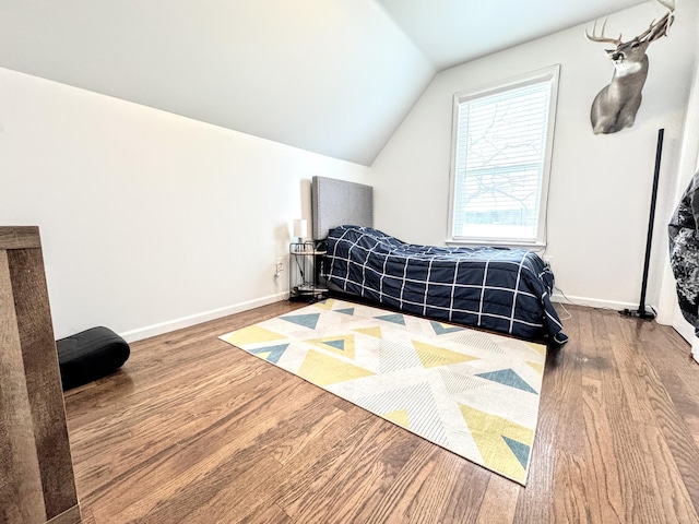 bedroom featuring hardwood / wood-style flooring and vaulted ceiling