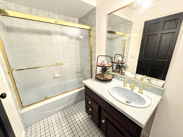 bathroom with enclosed tub / shower combo, vanity, and tile patterned flooring