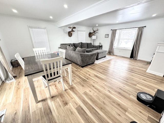 living room featuring light hardwood / wood-style flooring and ornamental molding