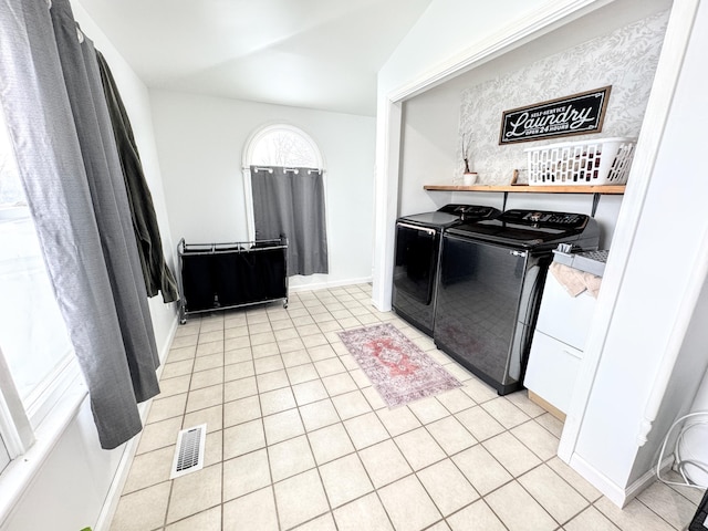 washroom featuring independent washer and dryer and light tile patterned flooring