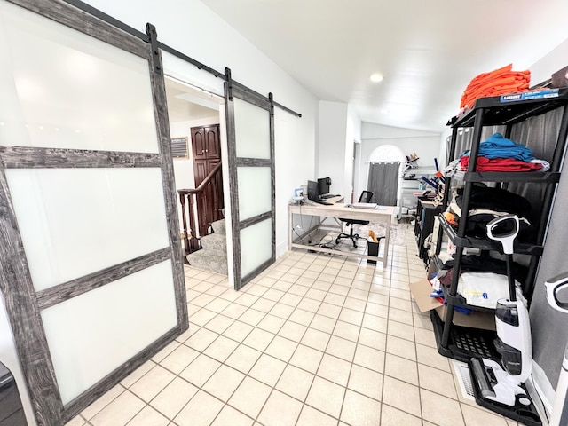 interior space featuring a barn door and light tile patterned floors