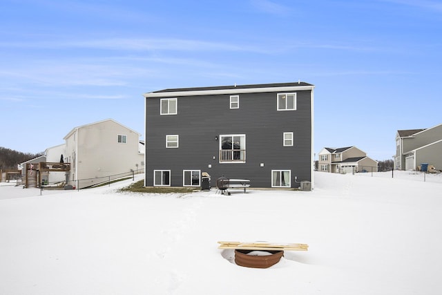 snow covered house with central AC unit