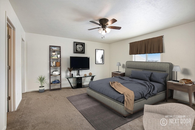 carpeted bedroom with a textured ceiling and ceiling fan