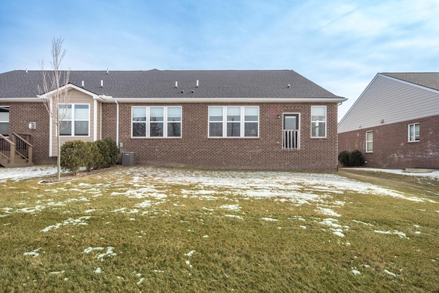 rear view of house featuring a yard