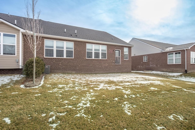 back of house with cooling unit and a yard