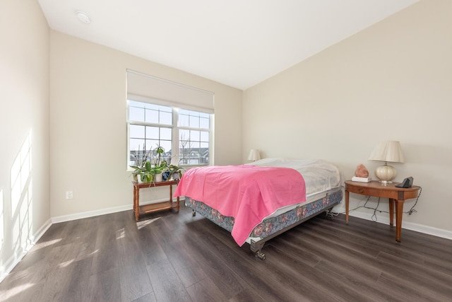 bedroom with dark hardwood / wood-style flooring