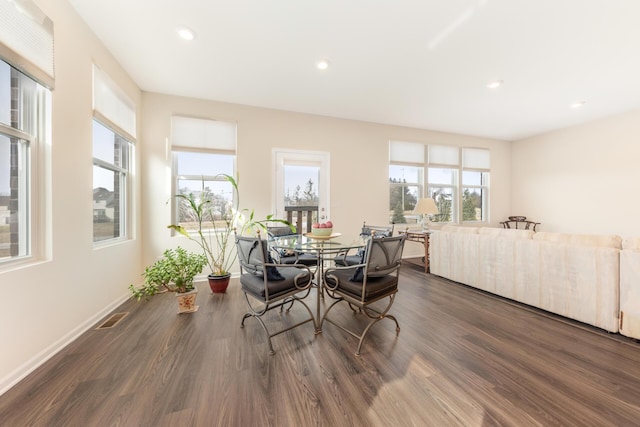 dining space with plenty of natural light and dark hardwood / wood-style floors