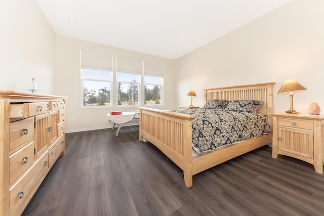 bedroom with dark hardwood / wood-style flooring