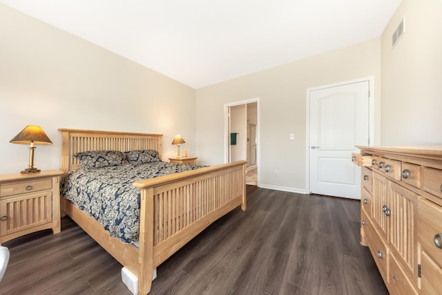 bedroom with dark hardwood / wood-style flooring