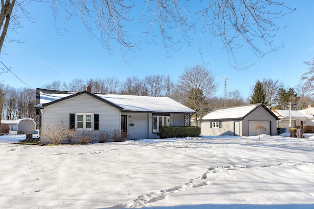 ranch-style house featuring an outbuilding and a garage