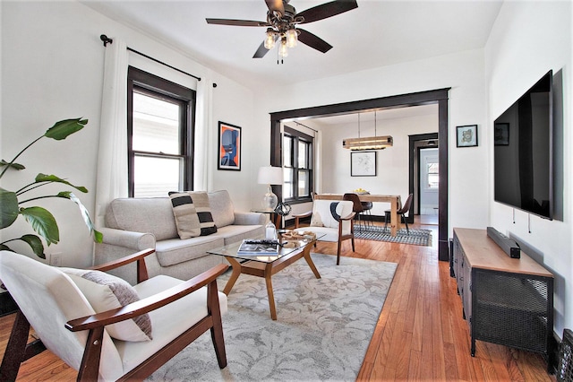 living room featuring ceiling fan and light hardwood / wood-style floors