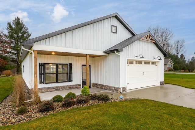 modern inspired farmhouse with a garage and a front lawn