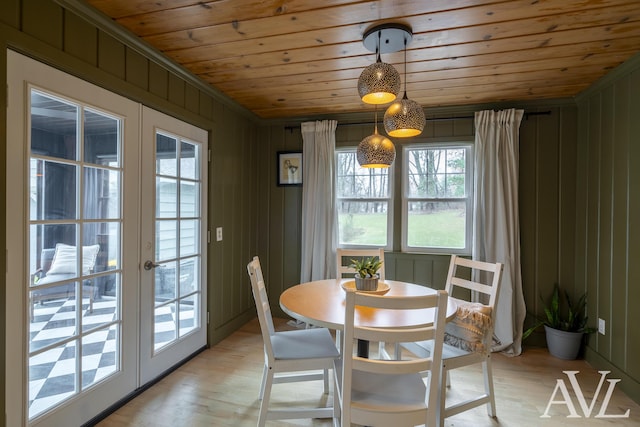 dining area with wooden ceiling, light wood-style flooring, and french doors