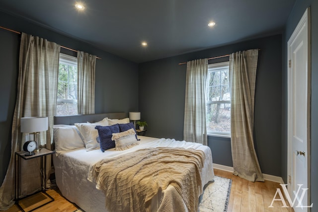 bedroom with recessed lighting, light wood-style flooring, and baseboards