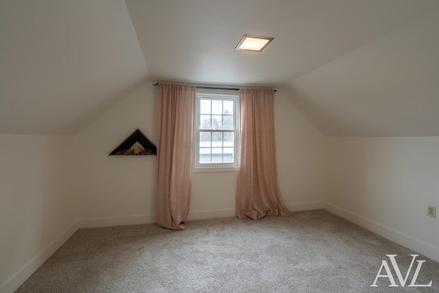 bonus room featuring vaulted ceiling, carpet flooring, and baseboards