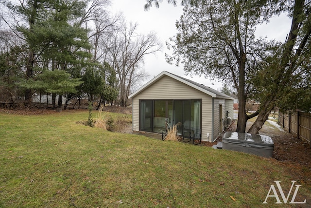 exterior space featuring a lawn and fence