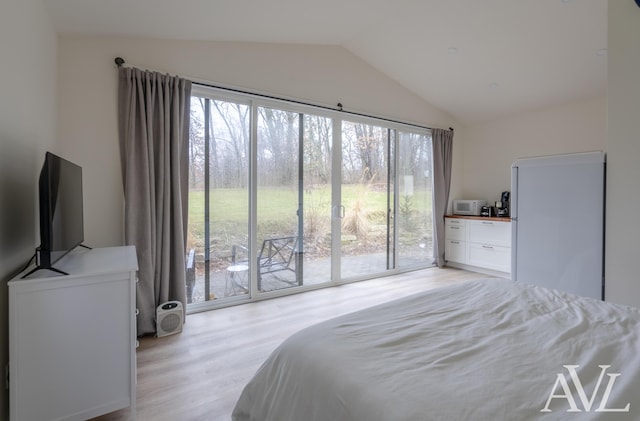 bedroom featuring vaulted ceiling, light wood-type flooring, and access to exterior