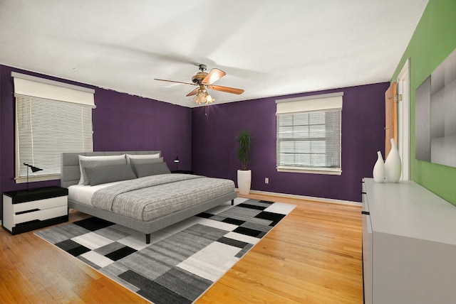 bedroom with hardwood / wood-style flooring and ceiling fan