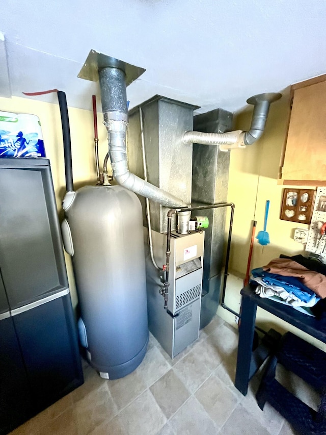 utility room featuring water heater