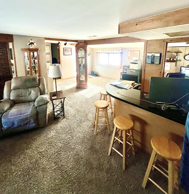 carpeted living room featuring bar area