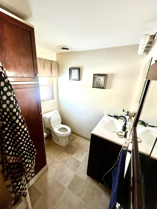 bathroom with vanity and toilet