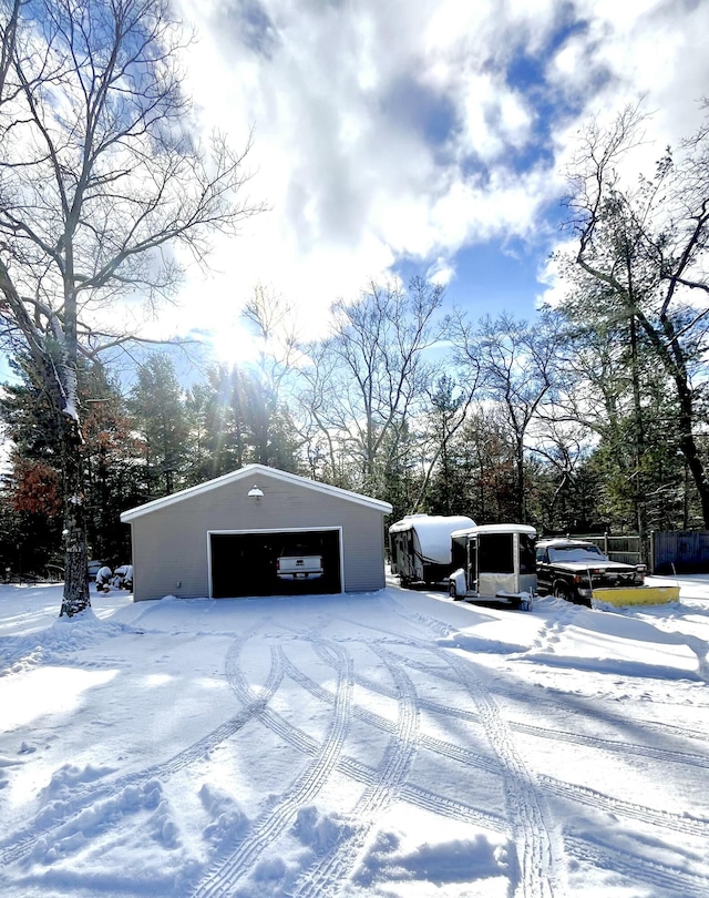 snow covered structure with a garage