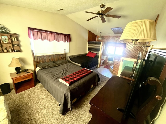 carpeted bedroom featuring ceiling fan, vaulted ceiling, and a textured ceiling