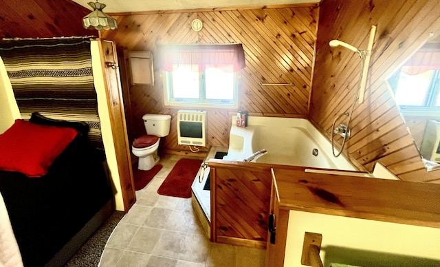 full bathroom with toilet, heating unit, vanity, wooden walls, and independent shower and bath