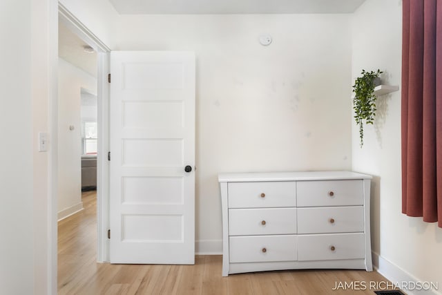 interior space featuring light wood-style flooring, visible vents, and baseboards