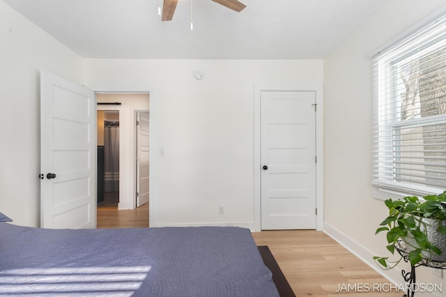 unfurnished bedroom featuring ceiling fan, light wood finished floors, and baseboards