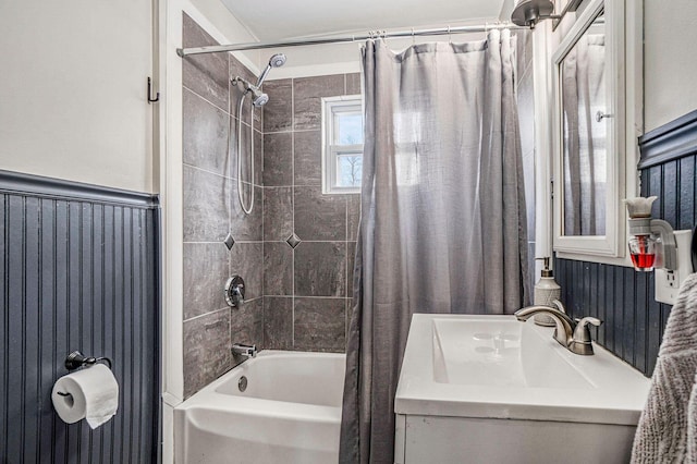 full bath featuring shower / tub combo, wainscoting, and vanity