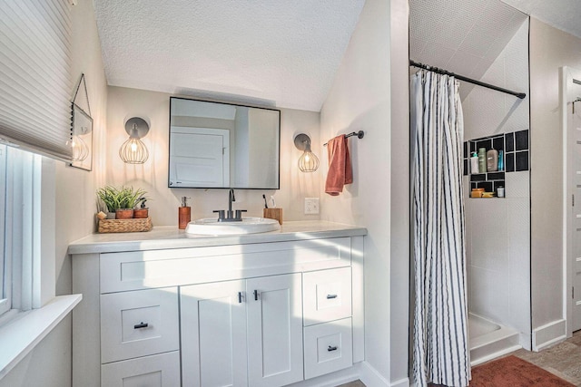 bathroom with a shower with shower curtain, a textured ceiling, and vanity