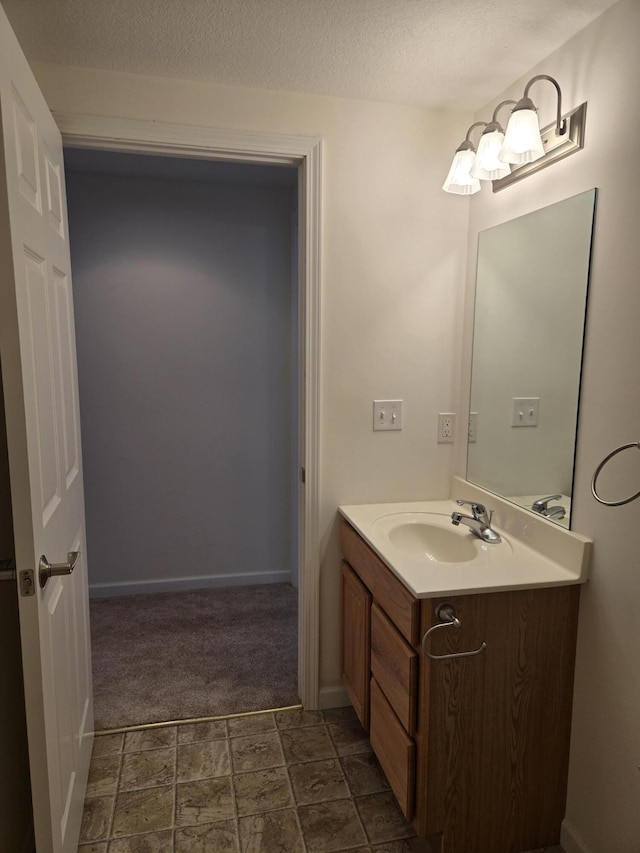 bathroom featuring vanity and a textured ceiling